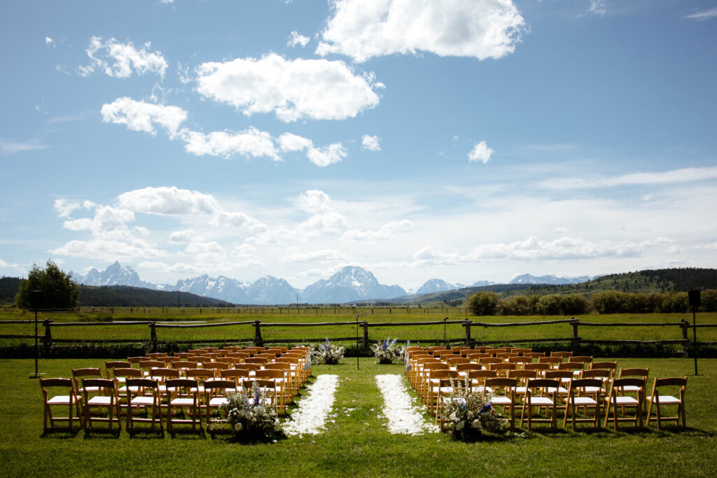 Wedding ceremony with white rose petals at Diamond Cross Ranch Jackson WY - Dandelion Floral