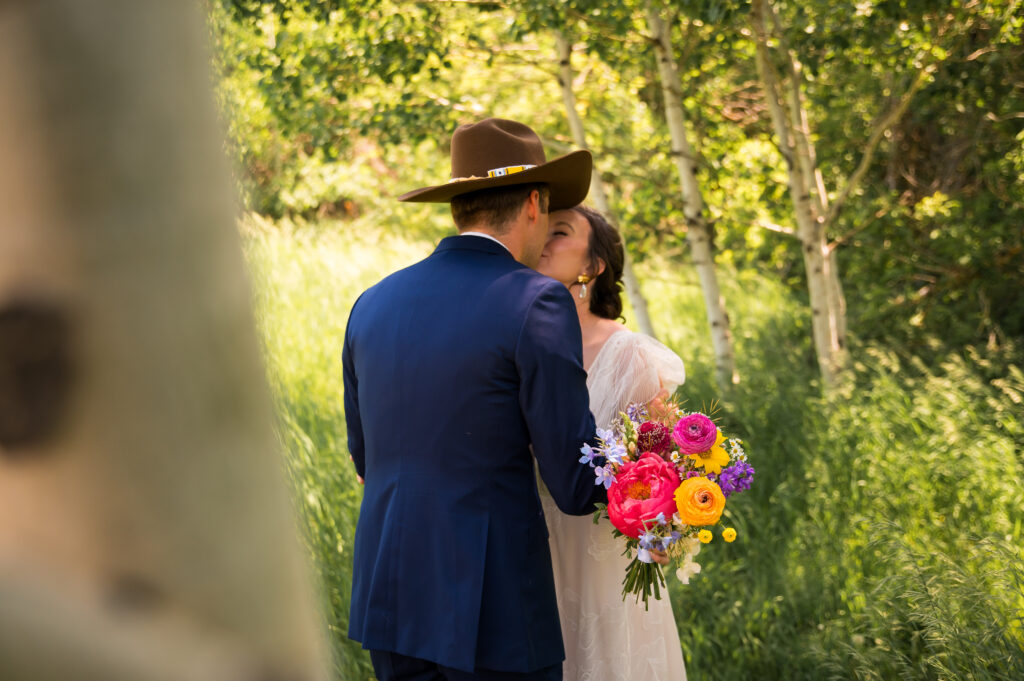 Bride holding mountain-inspired floral bouquet with vibrant blooms