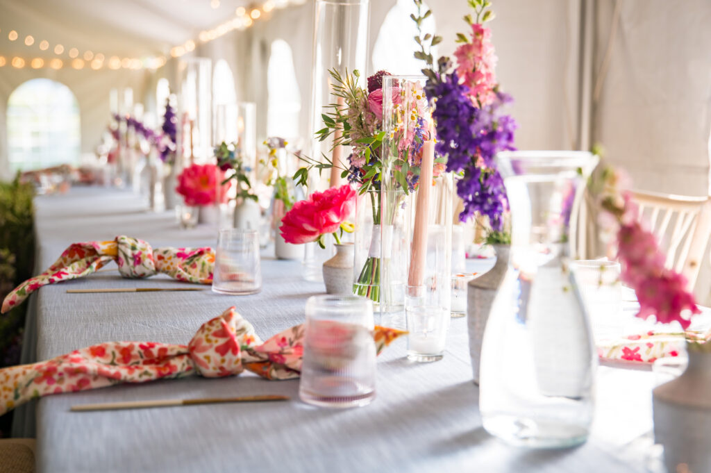 old, textural centerpieces with wildflowers and native lupine at head table