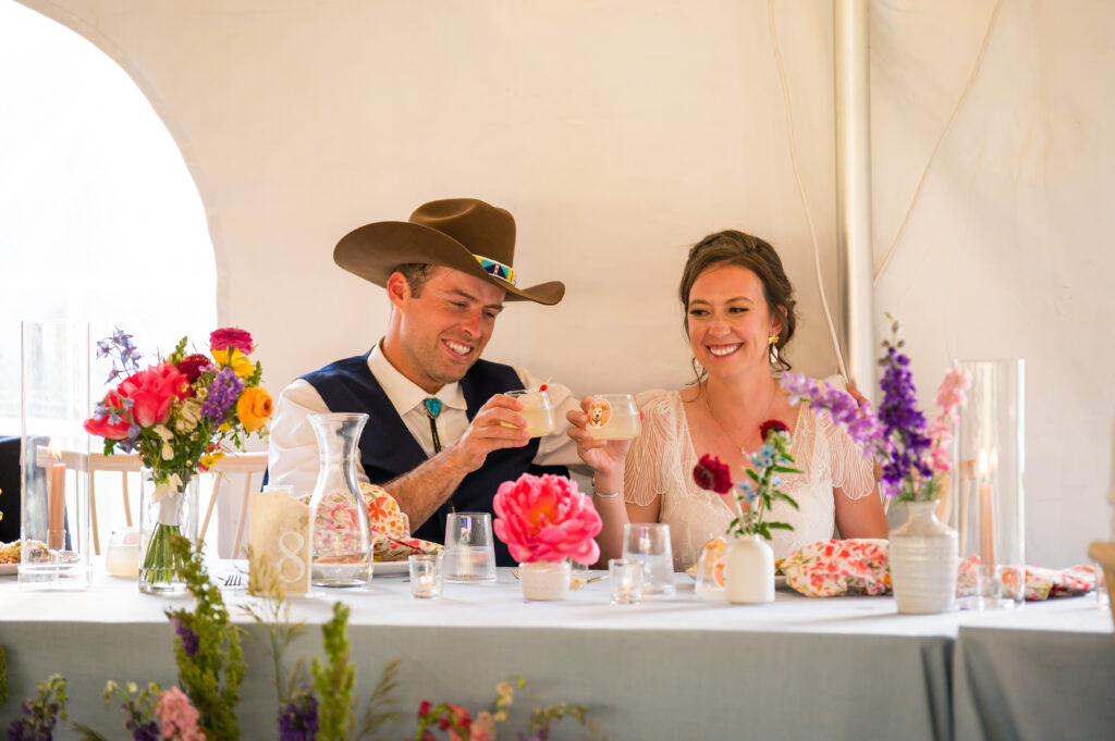 Wildflower tablescape with delphinium, ranunculus, and airy grasses