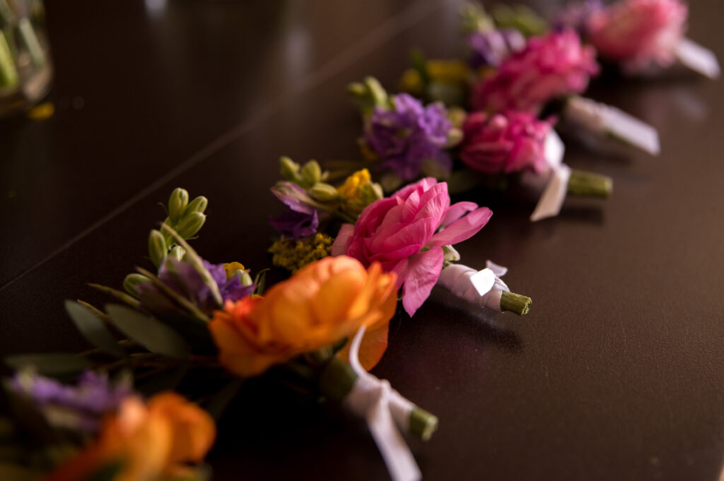 Detail of boutonniere with colorful ranunculus