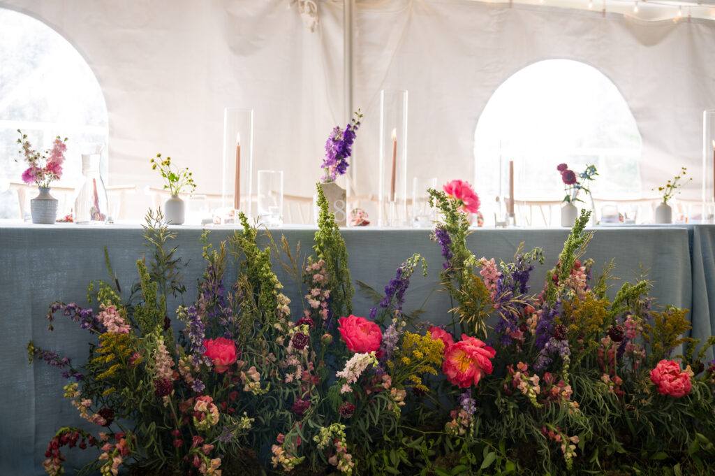 Reception table arrangement reflecting mountain meadow palette