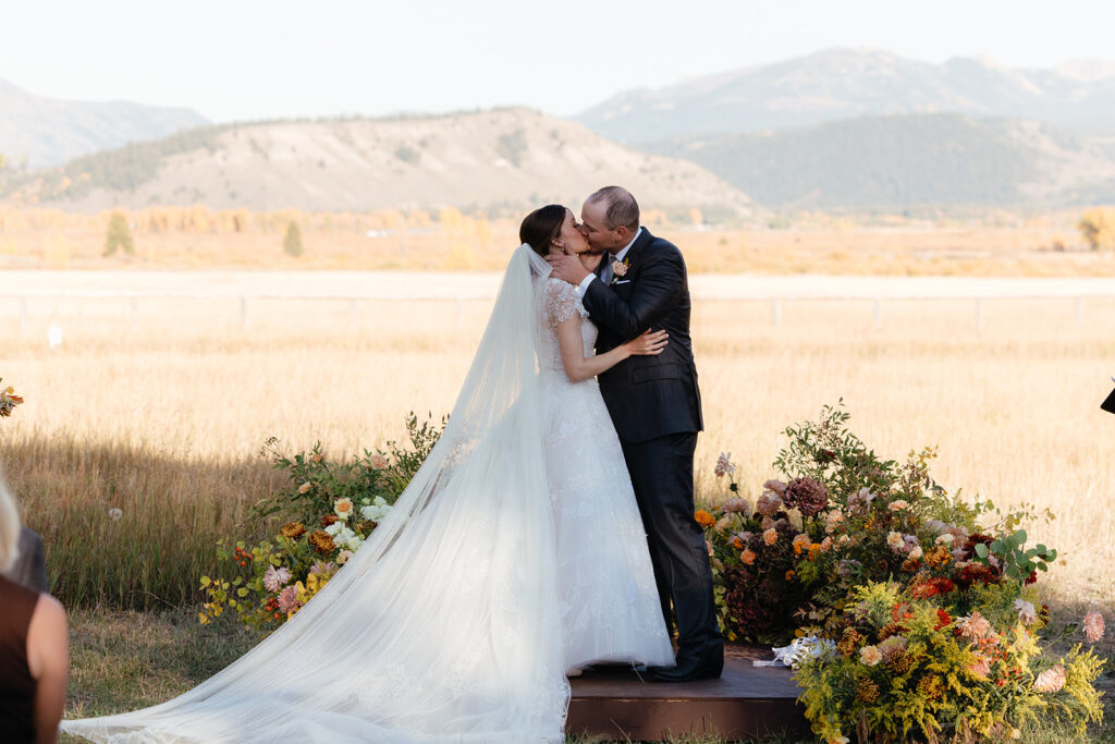 Fall ceremony with custom ground floral arrangements, or ground arbors, at ranch wedding in Jackson Hole Wyoming - by Dandelion Floral