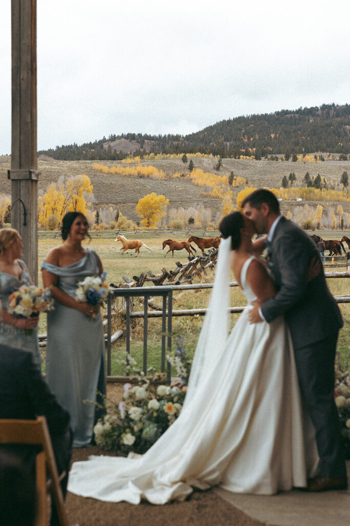 Bride and groom in front of horse release at Diamond Cross Ranch in Wyoming - flowers by Dandelion Floral
